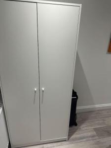 a large white wardrobe with a mirror in a room at London Victoria Green Park 15min in London +3 photos