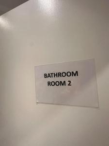 a sign on a ceiling that reads bathroom room at Piccadilly Circus 15minutes away in London +1 photo