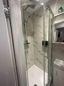 a shower with a glass door in a bathroom at London Waterloo Moments away in London