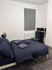 a bedroom with a blue bed with towels on it at Modern Central London Room Zone1 in London