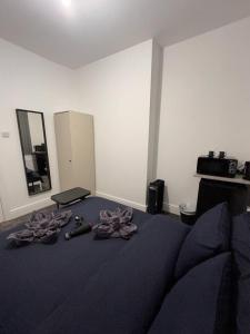 a bedroom with a bed with purple sheets and weapons at London Vauxhall - Victoria room in London