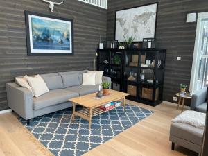 a living room with a couch and a coffee table at Cabin - Målselv fjellandsby in Bergset