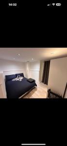 a bedroom with a black bed and a chair at Big Ben 15 minutes away in London