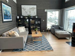 a living room with a couch and a table at Cabin - Målselv fjellandsby in Bergset +27 photos