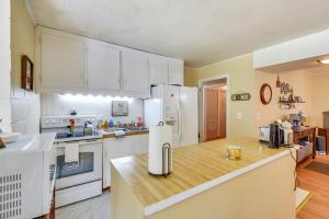 a kitchen with white cabinets and a wooden counter top at Seneca Abode with Furnished Deck Less Than 10 Mi to Clemson! in Seneca