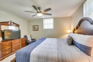 a bedroom with a bed and a flat screen tv at Seneca Abode with Furnished Deck Less Than 10 Mi to Clemson! in Seneca