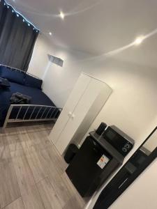 a bedroom with a blue bed and a tv at Central London Zone 1 in London