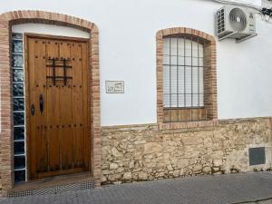 a wooden door on the side of a building at Casa el Chorro in Benalup Casas Viejas