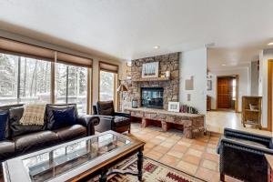 a living room with a couch and a fireplace at All-Season Chalet in Park City