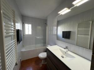 a white bathroom with a sink and a toilet at Villa Franca privat pool in L'Estartit