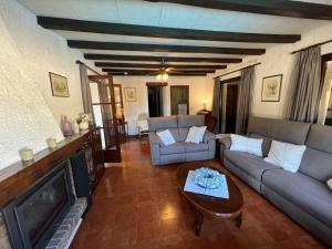 a living room with a couch and a table at Villa Franca privat pool in L'Estartit