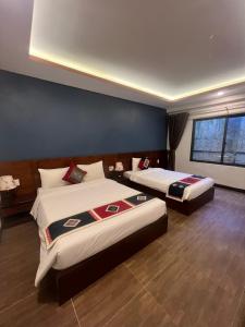 Sunshineview Sapa Hotel tesisinde bir odada yatak veya yataklar