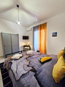 una camera da letto con un grande letto con cuscini gialli di Casa Imma a Napoli