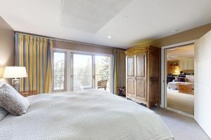 a bedroom with a large bed and a large window at Cascade Bay Getaway in Eastsound