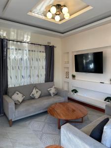 a living room with a couch and a table at Kumwitu Luxury Apartments in Lusaka