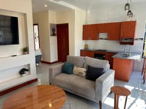 a living room with a couch and a table at Kumwitu Luxury Apartments in Lusaka