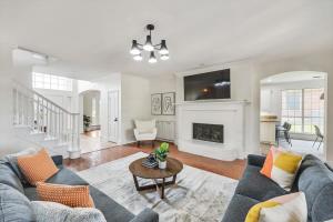a living room with a couch and a fireplace at Creekside Charm w Pool Backyard Oasis Patio in Plano