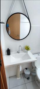 a bathroom with a sink and a mirror on the wall at Apartamento exclusivo, próximo a UFMS in Campo Grande