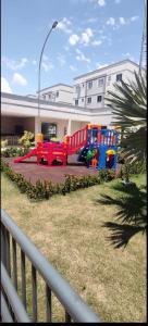 a playground in front of a building at Apartamento exclusivo, próximo a UFMS in Campo Grande