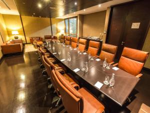 a dining room with a long table and chairs at NOI Vitacura in Santiago