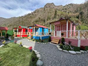 a row of colorful houses in a yard at River Land Rize in Ayder Yaylasi