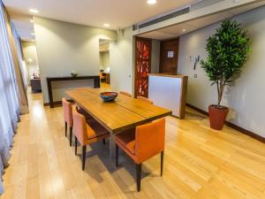 a dining room with a wooden table and chairs at NOI Vitacura in Santiago