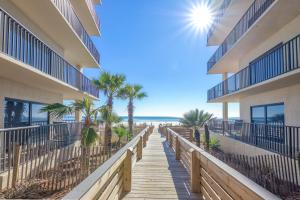 a boardwalk leading to the beach at a resort at The Palms 314 in Orange Beach