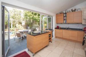 a kitchen with a table and a dining room at ※ Relaxing Home- Parking & Gorgeous Gardens (TSG)※ in Bath