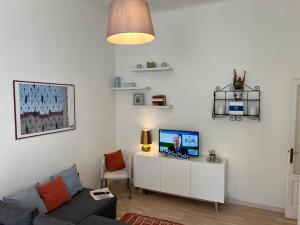 a living room with a couch and a tv at Lotti's House by Holiday World in Milan