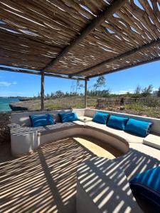 a patio with a couch and a view of the ocean at Sea view house in Kilifi