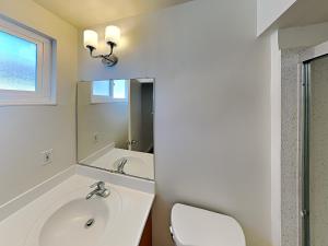 a bathroom with a sink and a toilet and a mirror at San Jose Apartment in San Jose