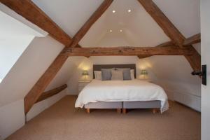 a bedroom with a white bed in the attic at ※ Charming Country House Nr Bath (WC)※ in Biddlestone