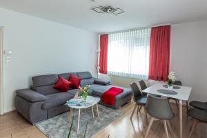 a living room with a couch and a table at Sea Rose in Friedrichshafen