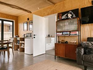 sala de estar con puerta blanca y cocina en Retro Style Beach Retreat - Matarangi Holiday Unit, en Matarangi