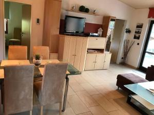 布特亚丁根E13 Ferienhaus mit Garten, Terrasse und Deichblick的带餐桌和电视的客厅 更多14张照片