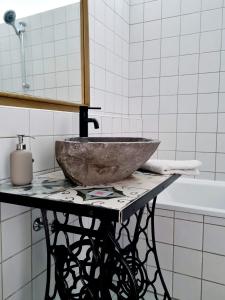 a bathroom with a stone sink on a table at Best Time In Graz in Graz