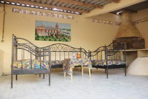 two beds in a room with a fireplace at Moyite Gandiol in Ndiébène