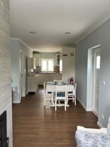 a dining room and kitchen with a table and chairs at Casa Santa Rita in Alcobaça +24 photos