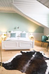 a bedroom with a white bed in a attic at Boutiquehotel Hubertushof in Bad Ischl