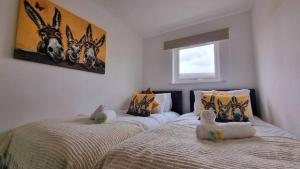 a bedroom with two beds with stuffed animals on them at No.62 Fivedom - Luxury apartment in Southampton