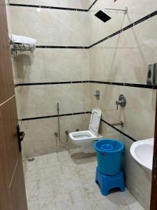 a bathroom with a toilet and a sink at Hotel Nirvan in Delhi