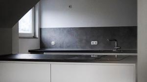 a kitchen with a sink and a counter top at Si-View Einzelzimmer mit Balkon Zimmer 5 in Siegen