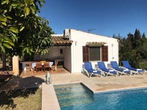 a villa with a swimming pool in front of a house at Cozy cottage with private pool , BBQ & Free Wifi in Pollença