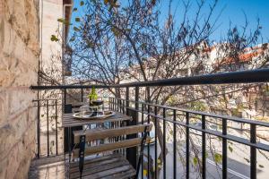 a balcony with a wooden table and a bench at dining room, bedroom and balcony in Jerusalem