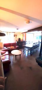 sala de estar con sofá, mesa y sillas en Villa de 5 chambres avec piscine privee jacuzzi et jardin amenage a Saint Paul de Varax, en Saint-Paul-de-Varax