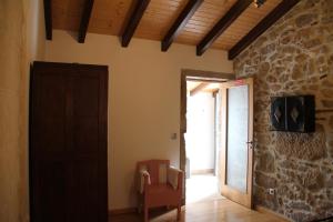a room with a door and a room with a chair at Casa Maria da Assunção in Vila Nova de Cerveira