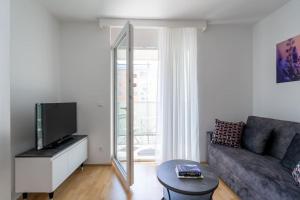 a living room with a couch and a tv at 1BR with Balcony, Urban Style by HM in Vienna