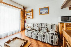 ein Wohnzimmer mit einem Sofa und einer Mikrowelle in der Unterkunft Bon Nant furnished flat in Saint-Gervais-les-Bains