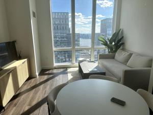 a living room with a couch and a table at Skyline vie, Luxury, Quiet 1br in New York