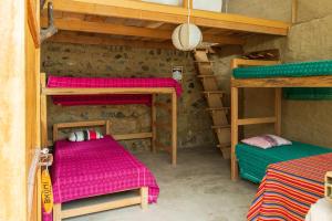 a room with two bunk beds in a house at Vrindavan Perú Jardín Ecológico in Matucana
